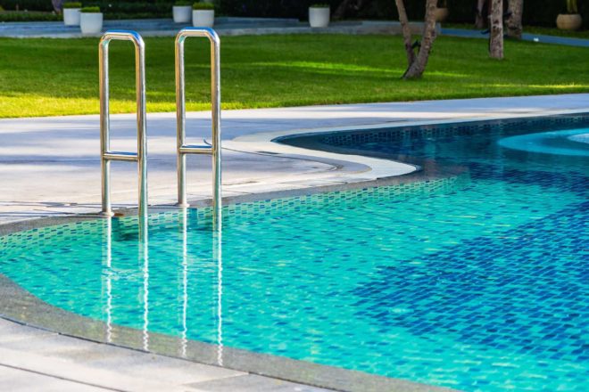 Photo of pool with stairs and drain around it